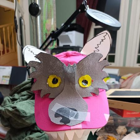 Pink cricketing hat with final wolf face.