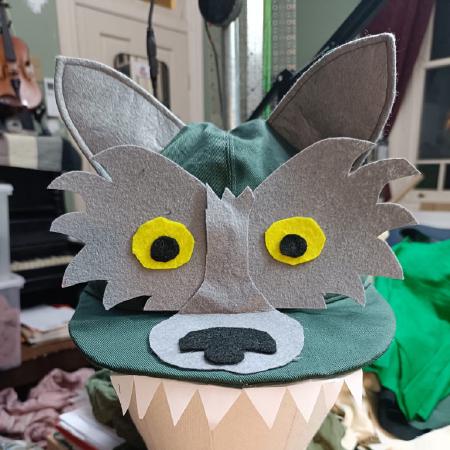 Green hat with ears, face and teeth.